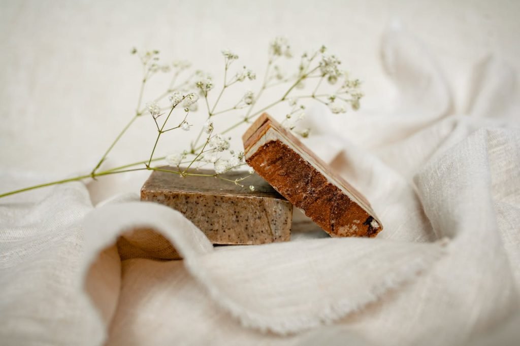 Elegant arrangement of handmade soaps with babys breath on soft fabric.