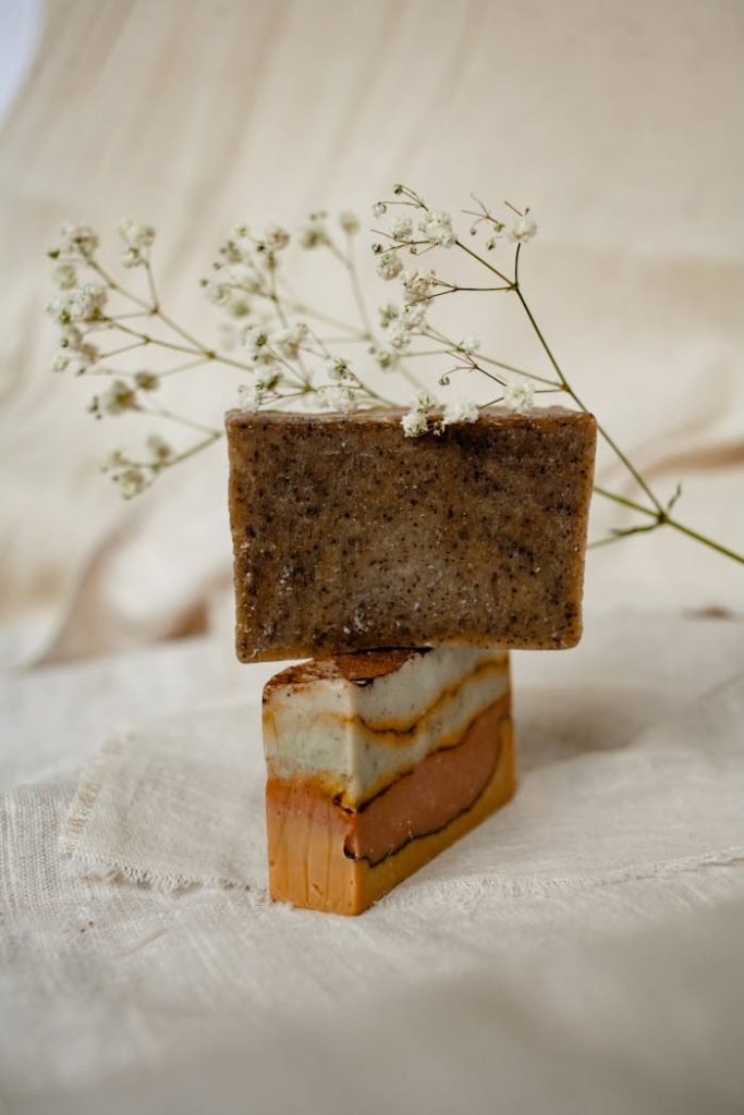 Aesthetic display of handcrafted organic soap bars with delicate white flowers.